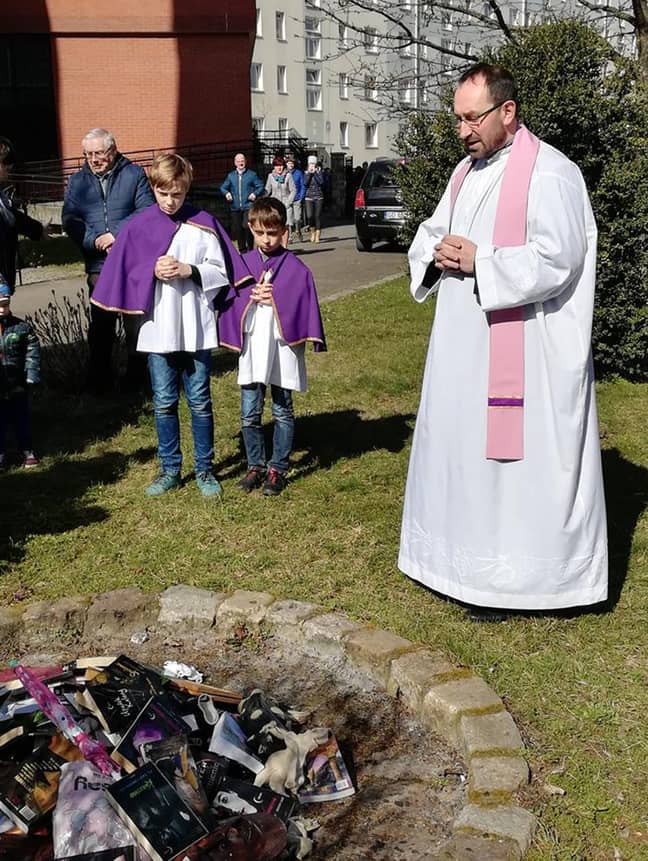 牧师和祭坛男孩帮助烧了书。学分：cen/@smsznieba