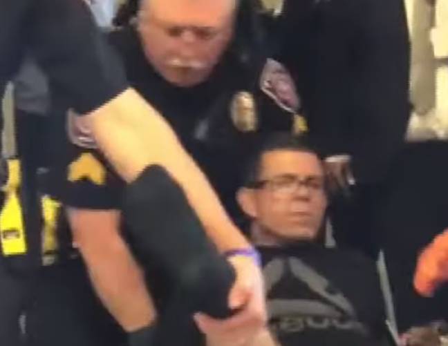 他被机场警察戴上手铐到轮椅上。信用：ABC新闻必威杯足球